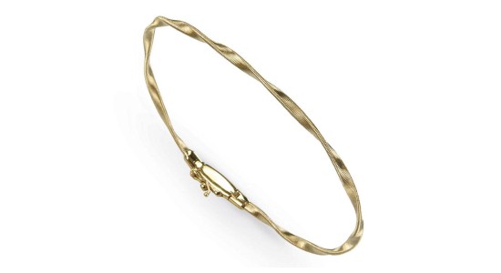 A yellow gold twisted coil bangle bracelet, available at Wilson & Son Jewelers.