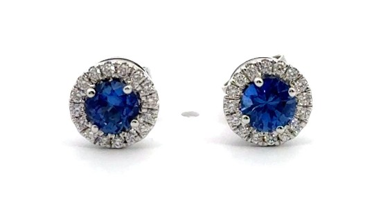 A pair of Martin Flyer white gold stud earrings featuring halo set sapphires, available at Wilson & Son Jewelers.