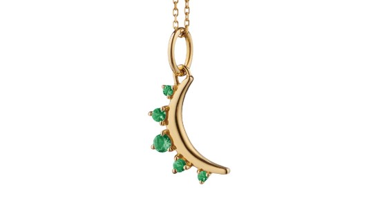 A yellow gold half sun pendant necklace featuring emeralds from Monica Rich Kosan, available at Wilson & Son Jewelers.