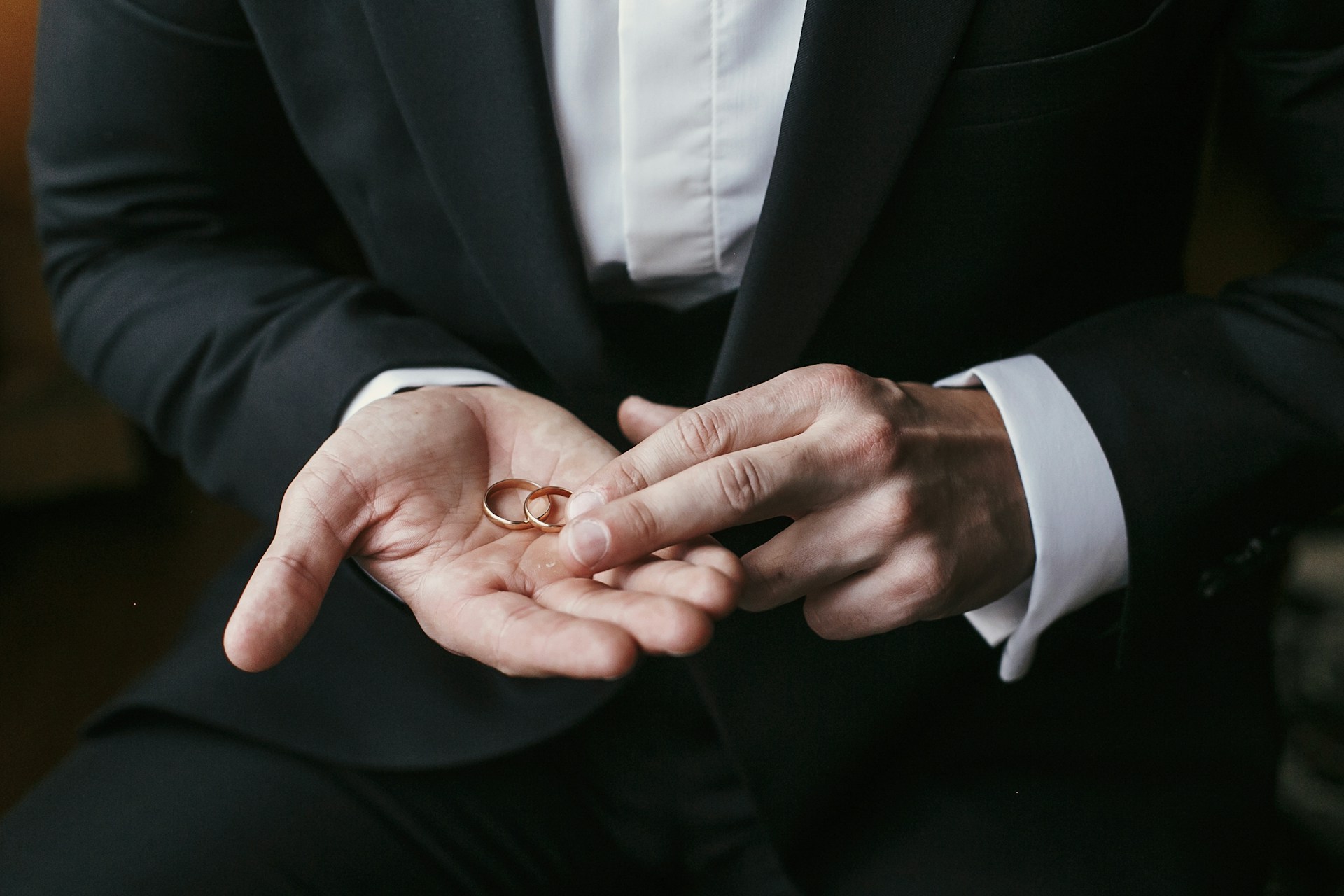 matching wedding bands on mans palm