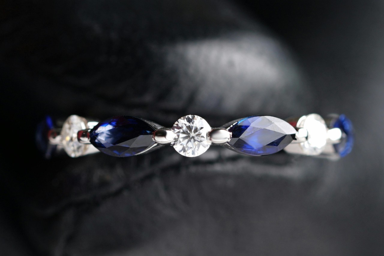 A stunning white gold anniversary band with diamonds and sapphires.