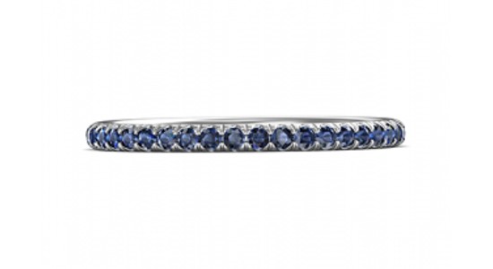 A white gold eternity wedding band set with sapphires, available at Wilson & Son Jewelers.