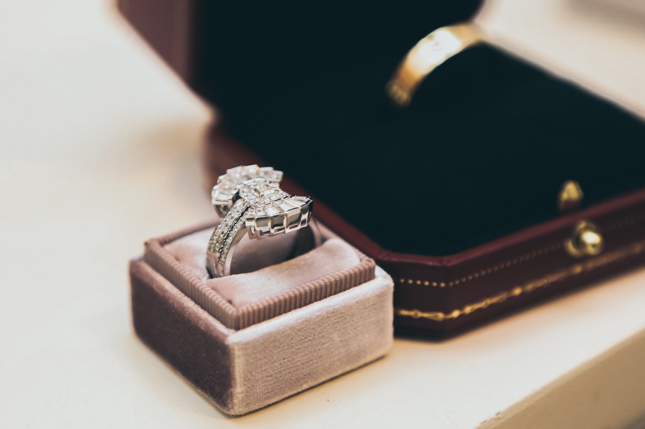 An Art Deco engagement ring in a pink ring box.